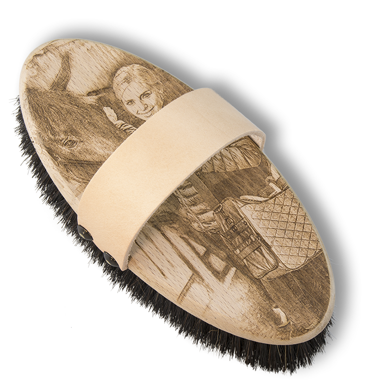photo engraving on horse grooming brush black background